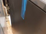 an image of a refrigerator with a blue tape on it