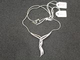 a silver necklace and earphones laying on the floor