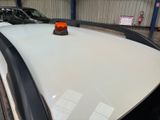 a white police car with a red light on top of it