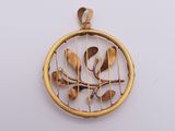 an image of a gold plated pendant with spoons and leaves on it
