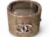 a silver bracelet with a chanel logo on it