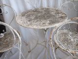 two chairs and a table with a white table cloth on it