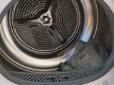 a close up of a washing machine with the door open