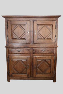 an old wooden cabinet with two doors and two drawers