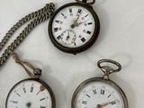 several different types of pocket watches are displayed on a white surface