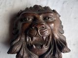 a close up of a lion head on a marble table