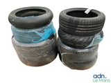 four tires stacked on top of each other on a white surface