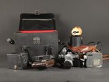 many different types of cameras sitting on a table
