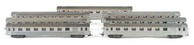 three silver train cars are stacked on top of each other