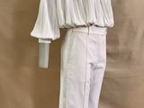 the mannequin is wearing white pants and a white top