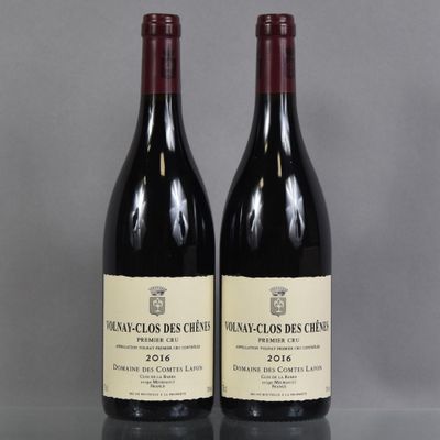 two bottles of wine sitting on top of a table next to each other