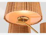 the lamp is on and has a brown shade on it