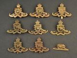 six pairs of royal military badges on a black surface