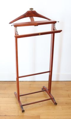 a wooden coat rack with a wooden hanger on it