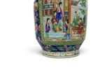 a vase with a painting on it sitting on a table