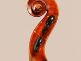 a close up of a violin on a stand with a white background
