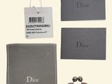 a close up of a pair of earrings and a wallet on a table