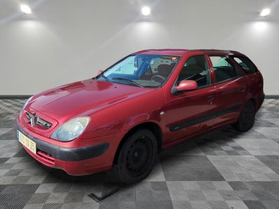 a picture of a red car that is parked in a garage