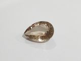 a close up of a brown diamond on a white surface