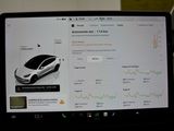 a laptop with a car on the screen on a desk