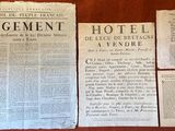several old newspapers sitting on top of a wooden table next to each other