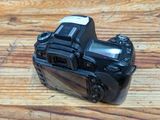a black camera sitting on a wooden table