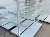 many shelves with glass shelves on them in a store