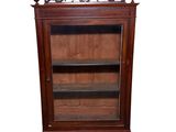 an image of a wooden cabinet with a glass door and shelves