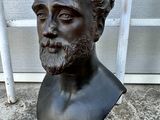 statue of a man with a beard and a mustache on a pedestal