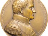 an image of a gold medal with a portrait of a man on it