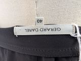 the label on the back of a black and white dress