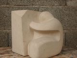 a white sculpture sitting on top of a wooden table
