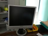 a computer monitor sitting on a desk with a keyboard and mouse