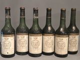 six bottles of wine are lined up in a row on a table