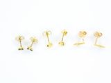three pairs of gold and blue stone stud earrings on a white background