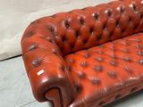 leather sofa with buttoned arms and tufted upholstered back