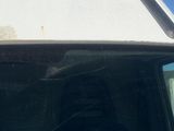 a dirty windshield of a white truck with a dirty windshield