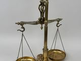 an antique brass scale with two scales on each side