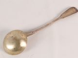 a spoon that is sitting on a white surface
