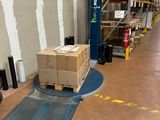 a forklift with a box on the floor in a warehouse