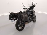a motorcycle that is parked in a room with white walls