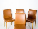 four brown leather chairs are arranged in a circle on a white background