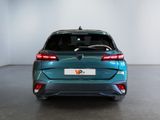 the rear end of a blue car in a white room