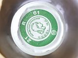 a close up of a bottle with a green label on it
