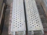 several pieces of metal are stacked on pallets in a warehouse