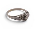 a close up of a ring on a white surface with a white background