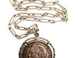 a close up of a chain with a coin on it