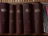 many books on a shelf in a library
