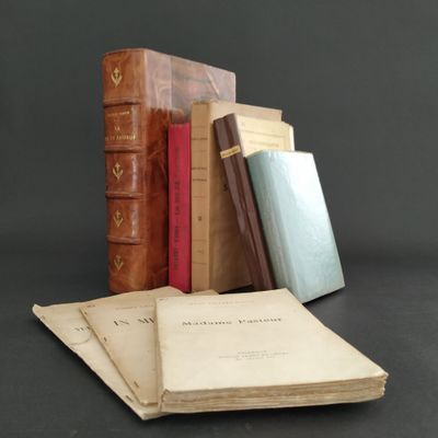 several old books are stacked on top of each other on a table
