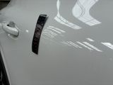a close up of a car door handle with a sticker on it
